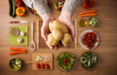 Fresh potatoes in hands clipart