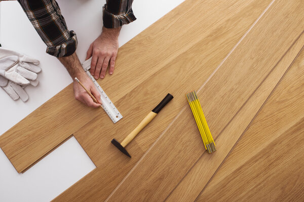 Carpenter installing a wooden flooring