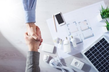 Contractor and customer shaking hands