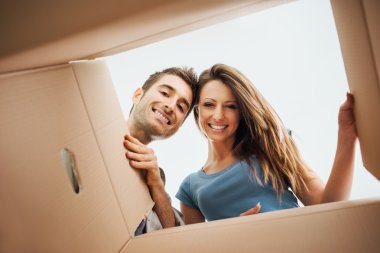 Happy couple opening a box clipart