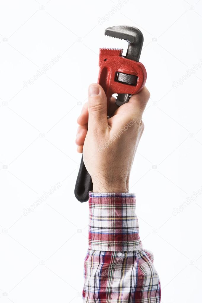 Hand holding a pipe wrench