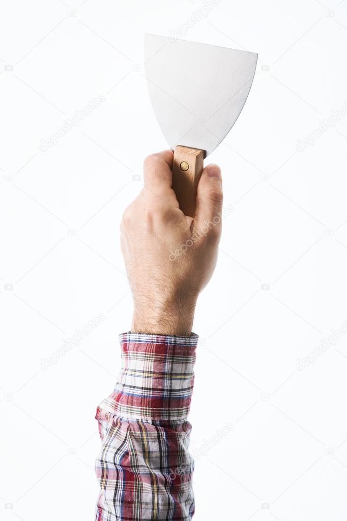 Hand holding a plaster spatula