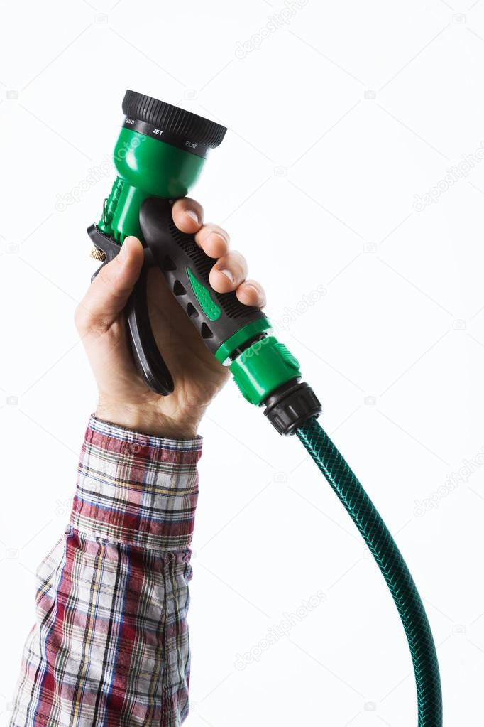 Hand holding a sprinkler hose