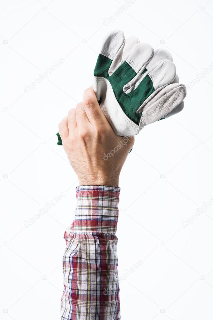 Hand holding gardening gloves
