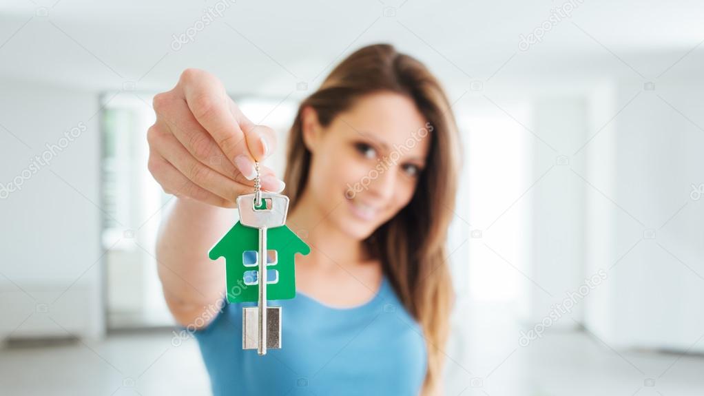 Beautiful woman holding house keys