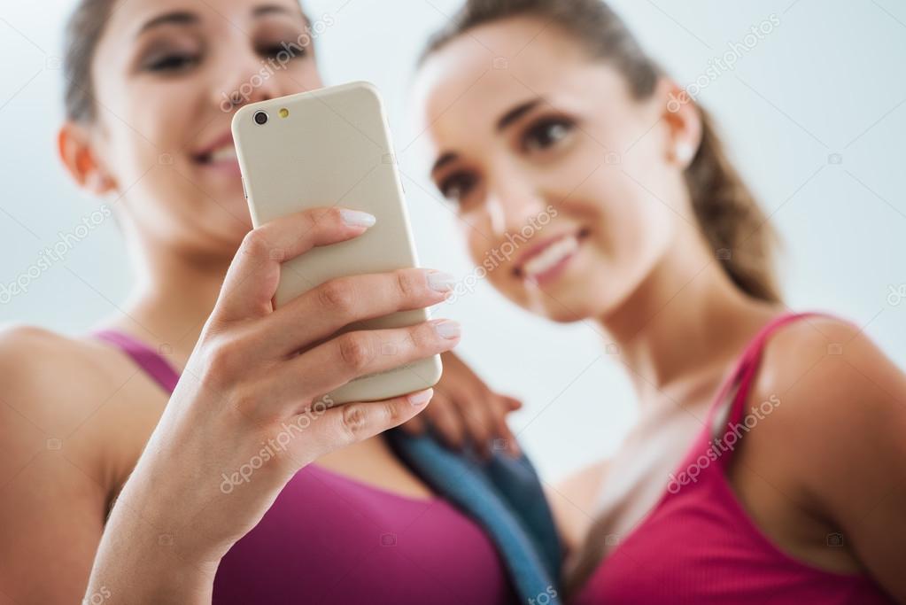 Happy girls using a fitness app