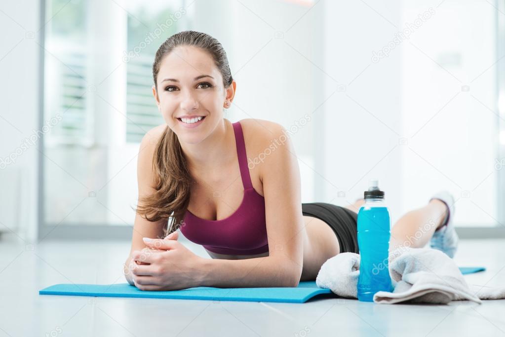 Smiling woman relaxing after workout