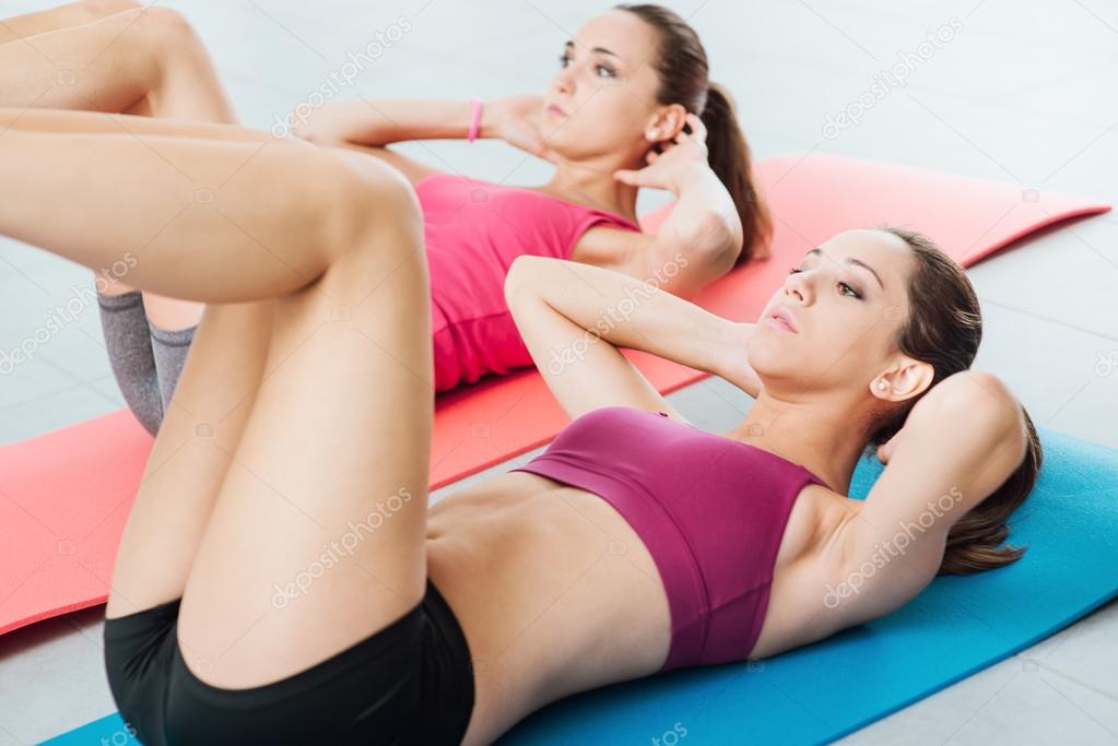 Young women doing abs workout at the gym
