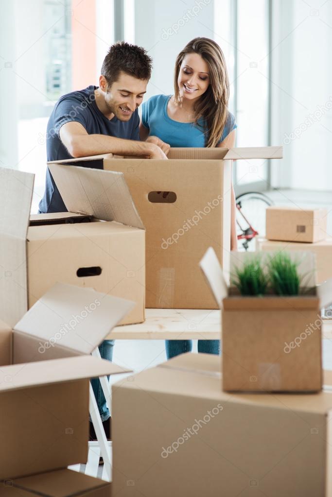 Smiling couple moving in a new house