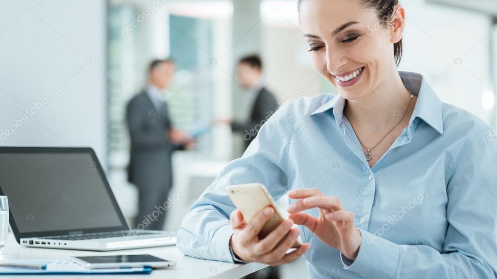Confident business woman using a smart phone