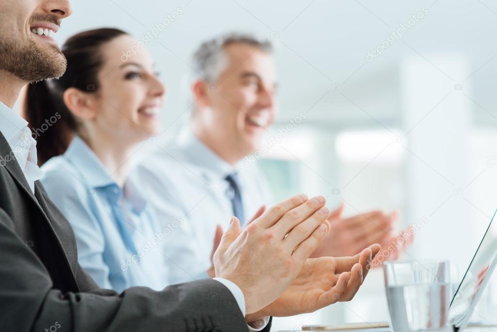 Business people clapping hands during a seminar