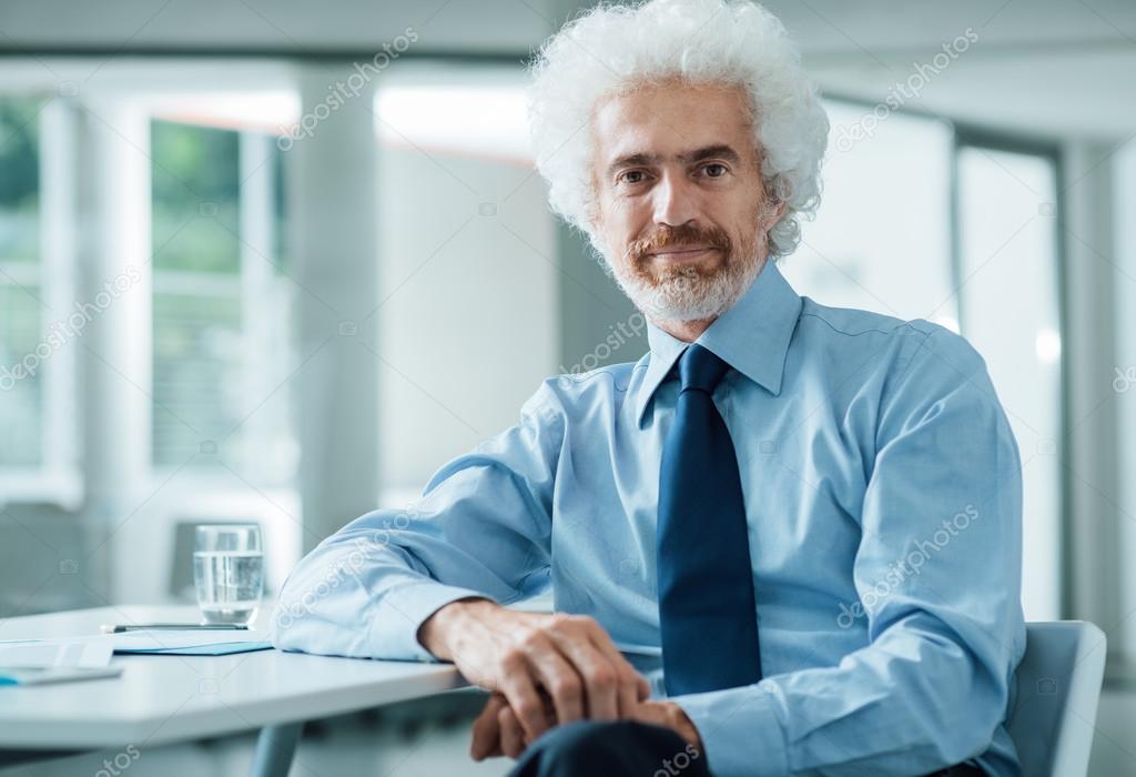 Adult businessman at the office posing