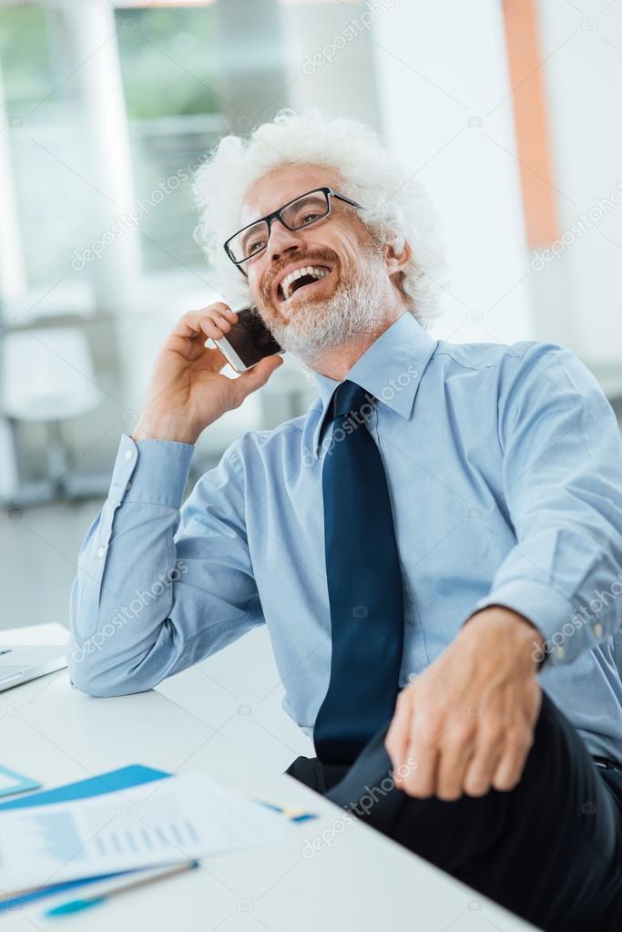 Happy businessman on the phone