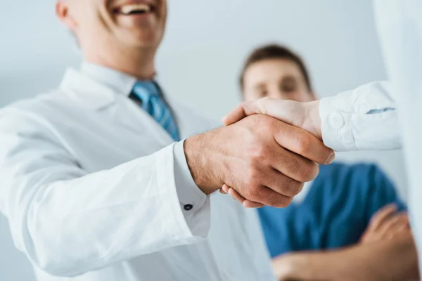 Doctors handshaking at hospital — Stock Photo, Image