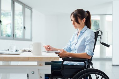 Confident disabled businesswoman at work