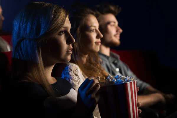 Friends at the cinema watching a movie — Stock Photo, Image