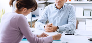 Human resources, aMature businessman and young woman having a business meeting in the office