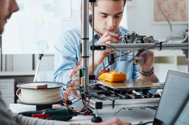 Students using a 3D printer