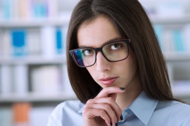 Confident businesswoman thinking