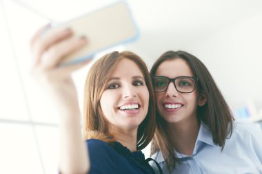 Friends shooting self pictures with a mobile