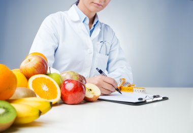 Professional nutritionist writing medical records clipart