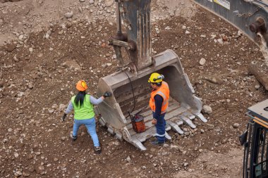İnşaat işçileri temeli hassasiyet ve güçle güçlendiriyor. Her hareket yeteneği, güvenliği ve kendini adamayı yansıtır. Daha büyük bir şeyin yükselişi için temel oluşturur..