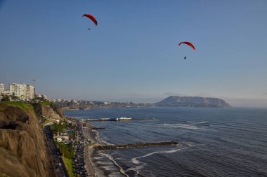 Pasifik aşağıdaki uçurumların üzerinde süzülen paragliderler adrenalini, özgürlüğü ve Limas ikonik kıyı manzarasını unutulamaz bir uçuşla harmanlıyorlar..
