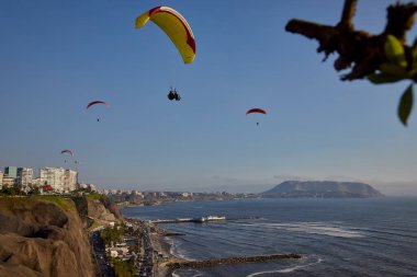 Pasifik aşağıdaki uçurumların üzerinde süzülen paragliderler adrenalini, özgürlüğü ve Limas ikonik kıyı manzarasını unutulamaz bir uçuşla harmanlıyorlar..