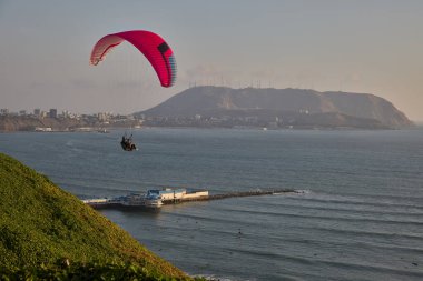 Paragliders soaring above the cliffs as the Pacific unfolds below, blending adrenaline, freedom, and Limas iconic coastal landscape into one unforgettable flight.