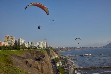 Paragliders soaring above the cliffs as the Pacific unfolds below, blending adrenaline, freedom, and Limas iconic coastal landscape into one unforgettable flight.