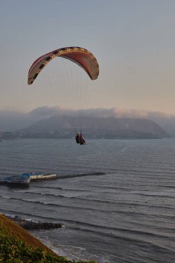 Pasifik aşağıdaki uçurumların üzerinde süzülen paragliderler adrenalini, özgürlüğü ve Limas ikonik kıyı manzarasını unutulamaz bir uçuşla harmanlıyorlar..