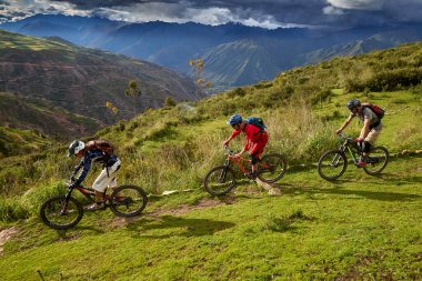Peru 'nun kutsal vadisi Cusco' da sınırlarını Andean manzaraları ve antik tarım arazileriyle çevreleyen dağ bisikletçileri zorluyor. Bu dinamik açık hava sahnesi macera seyahatini, aktif yaşam tarzını yakalar.,