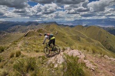 Peru, Cusco 'da antik dağlık patikalar boyunca seyahat eden bir grup dağ bisikletçisi, otantik yerel kültür, tarihi manzaralar ve uzak bir And ortamında aktif bir yaşam tarzı ve keşif ruhunu yansıtan açık hava maceraları yaşıyorlar..