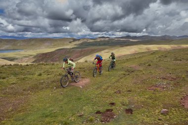 Peru 'nun kutsal vadisi Cusco' da sınırlarını Andean manzaraları ve antik tarım arazileriyle çevreleyen dağ bisikletçileri zorluyor. Bu dinamik açık hava sahnesi macera seyahatini yakalar.,