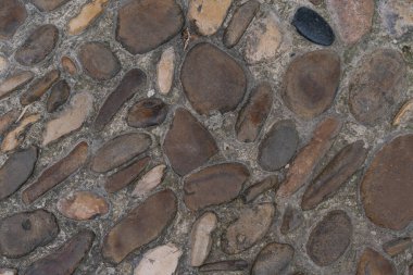 Taş duvar patırtısının dokusu arka planda. Eski Avrupa ortaçağ sokak kaldırımları.