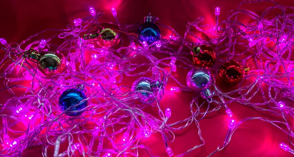 Christmas garland in purple light with new year toys