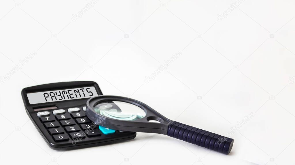 The text of payments is written on the display of the calculator, next to a magnifying glass is not a white background. Place for text.