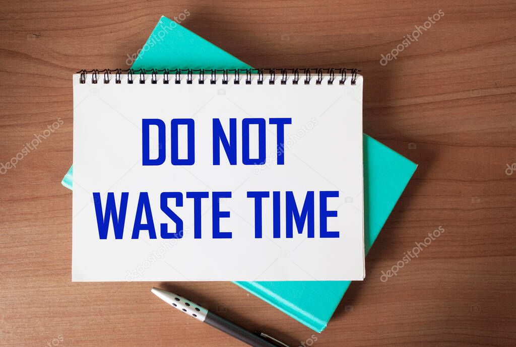 Don't waste time, text words written on notepad, on wooden background, motivational inspirational life and business concept