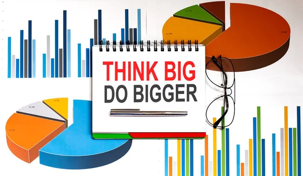 Think Big, Do Bigger Motivation quote. Success achievement concept written on notepad on charts