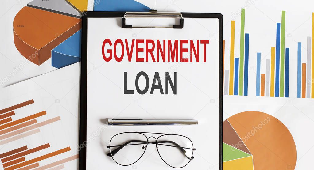 GOVERNMENT LOAN text . Conceptual background with chart ,papers, pen and glasses