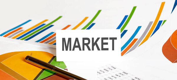 MARKET text on paper on the chart background with pen