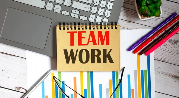 TEAM WORK written on notepad with office tools,business concept