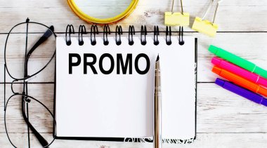 Blank sheet, pen and glasses on the grey table. PROMO