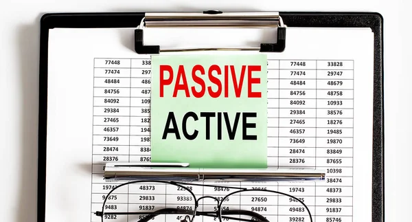 Closeup of deadline time of PASSIVE ACTIVE and glasses and pen
