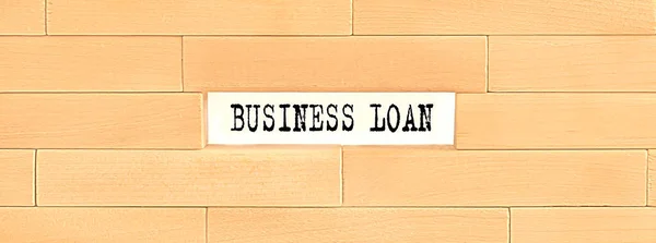 BUSINESS LOAN text on the wooden block wall, business
