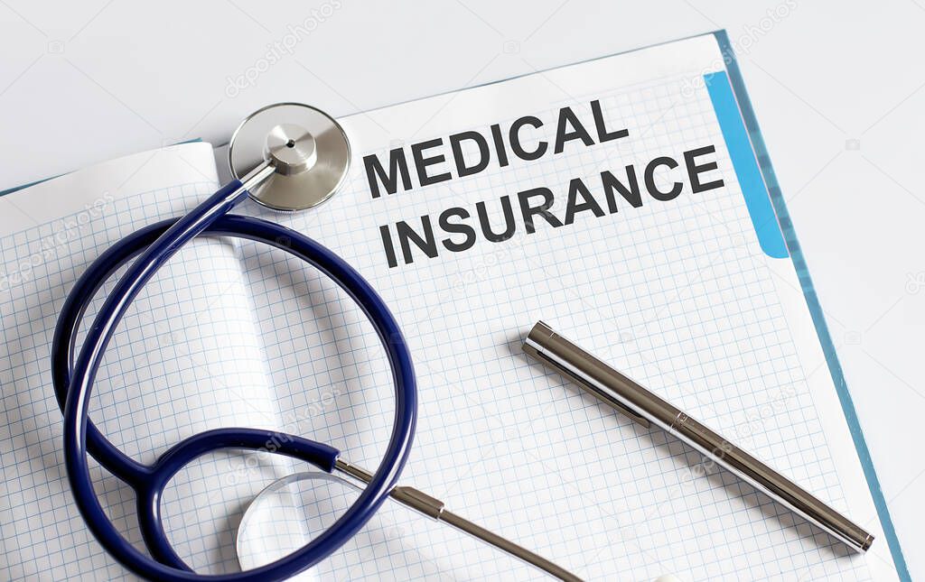 Paper with text MEDICAL INSURANCE on table with stethoscope