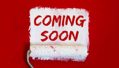 coming soon .One open can of paint with white brush on red background.
