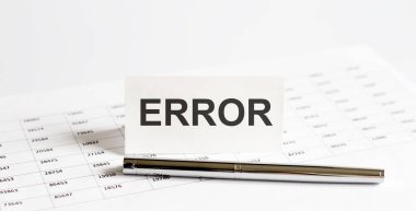 Text ERROR on stickers,pen on the background of documents. Financial bookkeeping, Accounting Concept. Top view.