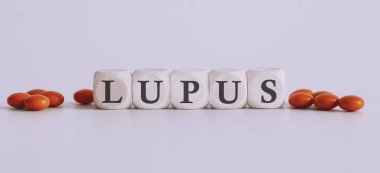top view blocks with word LUPUS on the white background with pills