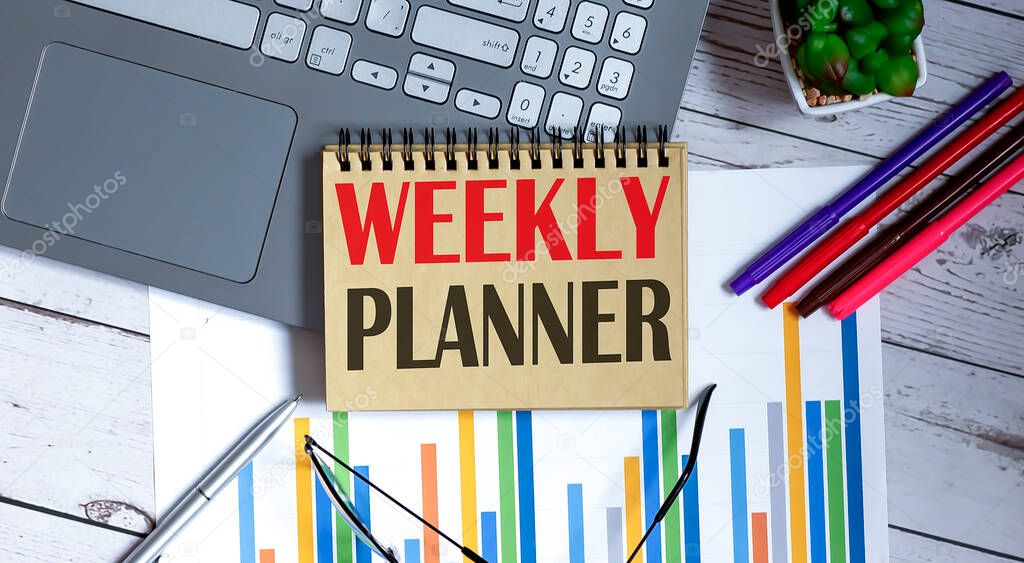 Time to WEEKLY PLANNER on notepad with office tools,business concept